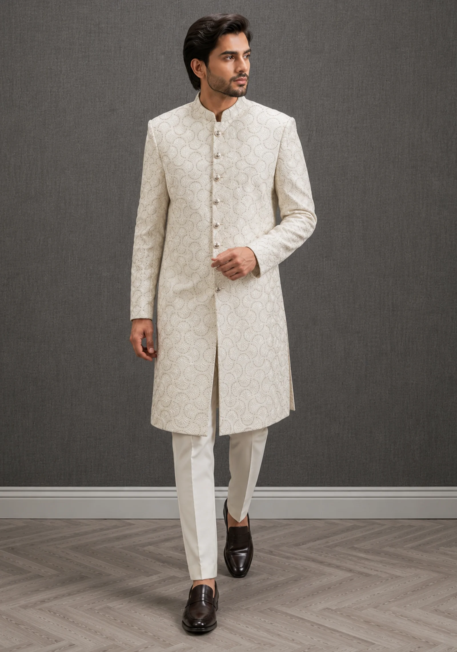 A gentleman wearing the "Ivory Regal Heritage" premium sherwani, showcasing sharp tailoring and refined hand-made Zari work surface ornamentation as seen in 50.webp, 51.jpg, 52.webp, and 53.jpg.