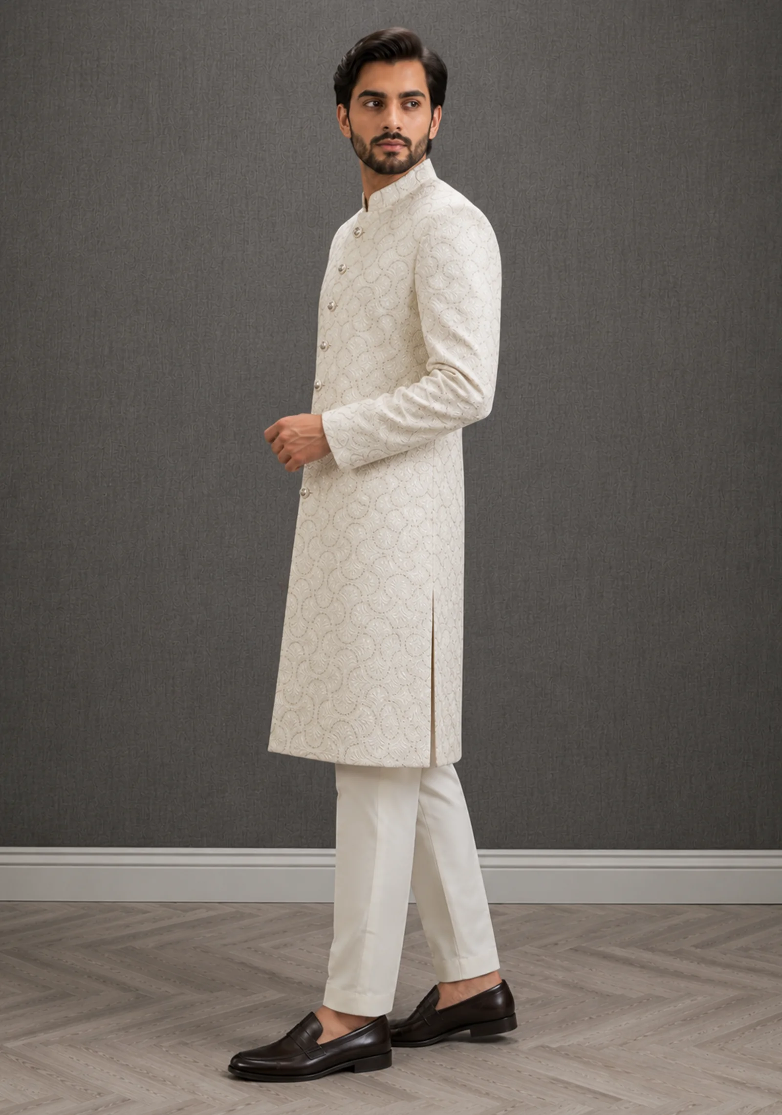 A gentleman wearing the "Ivory Regal Heritage" premium sherwani, showcasing sharp tailoring and refined hand-made Zari work surface ornamentation as seen in 50.webp, 51.jpg, 52.webp, and 53.jpg.