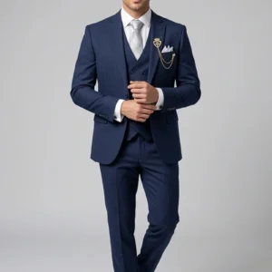 Model wearing the "Royal Crest" Navy Blue premium three-piece formal suit with signature brooch detail.