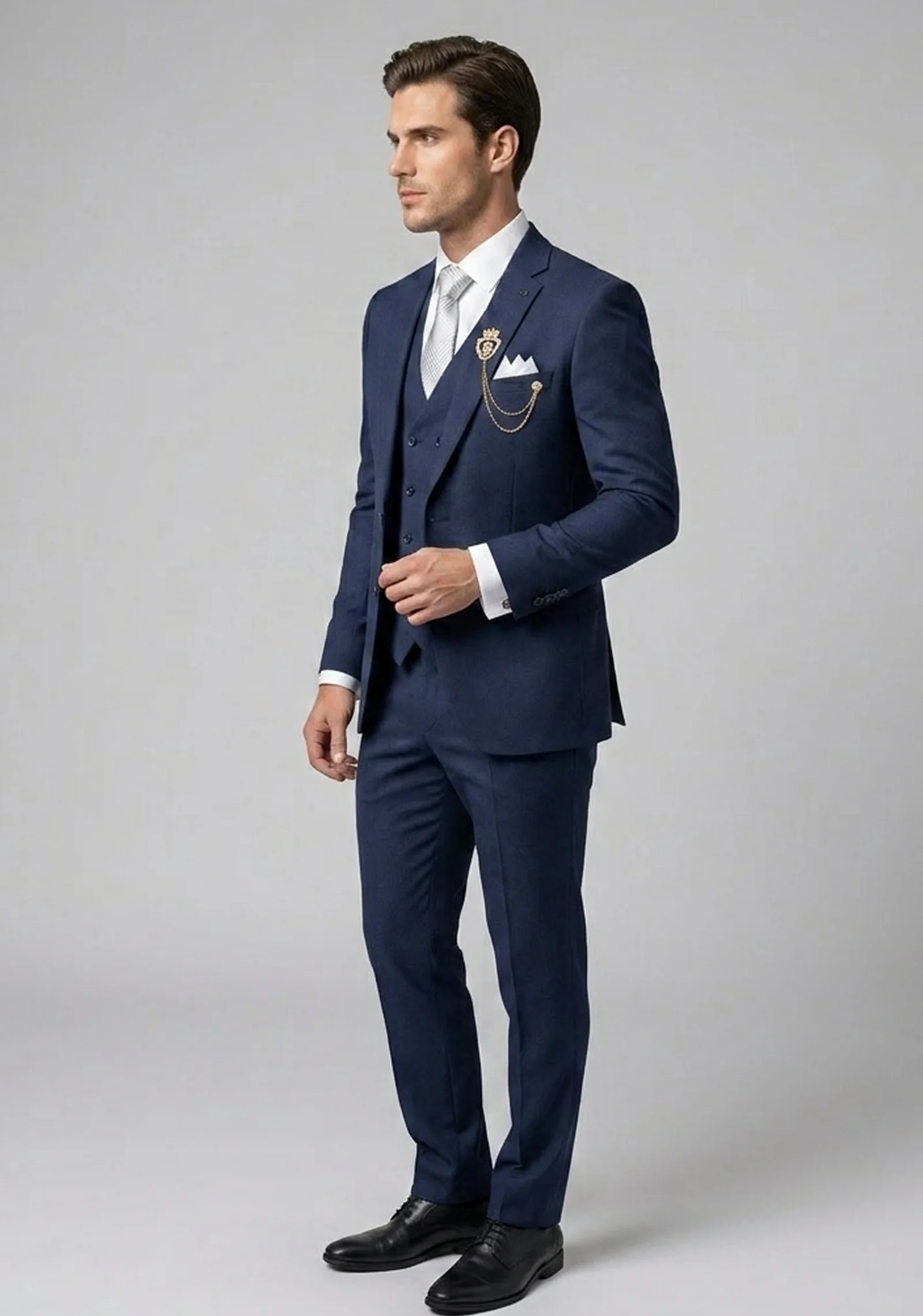 Model wearing the "Royal Crest" Navy Blue premium three-piece formal suit with signature brooch detail.