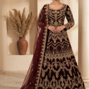 Model wearing a Royal Maroon Velvet Heritage Farshi Lehnga featuring detailed hand-made Zari work