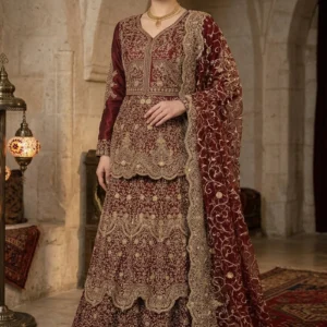 Deep maroon velvet tiered lehenga with gold handwork from AL Hassan Lehnga House