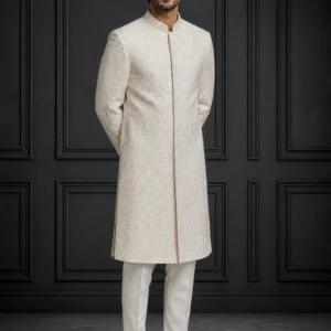A groom wearing the ivory Sadaf-e-Noor bespoke sherwani featuring intricate metallic thread detailing as seen in 11_7.webp, 12_7.webp, 13_5.webp, and 14_5.jpg.