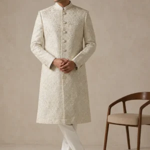 Model wearing the Ivory-Hisaar-Gul ivory bespoke Sherwani with architectural floral detailing as seen in 15.webp, 16.jpg, 17.webp, and 18.jpg.