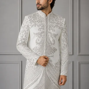 A model wearing the ivory and silver Mehtaab-e-Sim bespoke sherwani with intricate metallic thread detailing as seen in 2_2.webp, 3.webp, 4_2.jpg, and Untitled-1_2.webp.