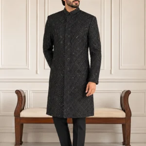 A gentleman wearing the "Midnight Obsidian Royal" premium sherwani, showcasing sharp tailoring and refined hand-made Zari work surface ornamentation as seen in 2.webp, 3.jpg, 4.webp, and Untitled-1.webp.