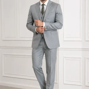 A gentleman wearing the "Silver Sovereign" premium three-piece suit in #a4a19a color, showcasing sharp tailoring and refined hand-made Zari work surface ornamentation as seen in 55.webp, 66.webp, 77.webp, and 99_2.webp.