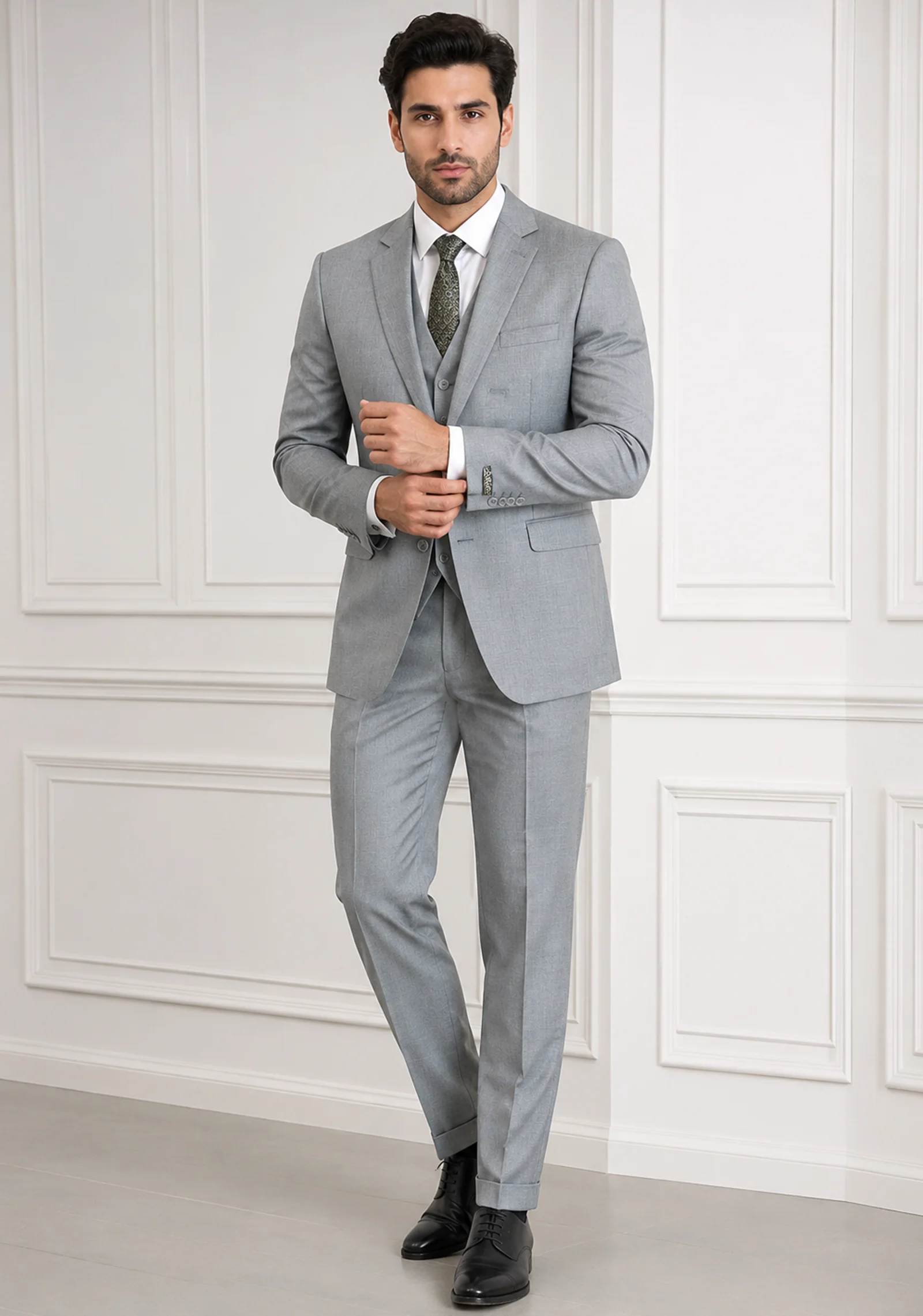 A gentleman wearing the "Silver Sovereign" premium three-piece suit in #a4a19a color, showcasing sharp tailoring and refined hand-made Zari work surface ornamentation as seen in 55.webp, 66.webp, 77.webp, and 99_2.webp.