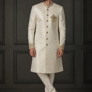 : A gentleman wearing the "Ivory Sovereign Heritage" premium sherwani, showcasing sharp tailoring and refined Zari work surface ornamentation as seen in 9.webp, 10.webp, 11.jpg, and 12.jpg.