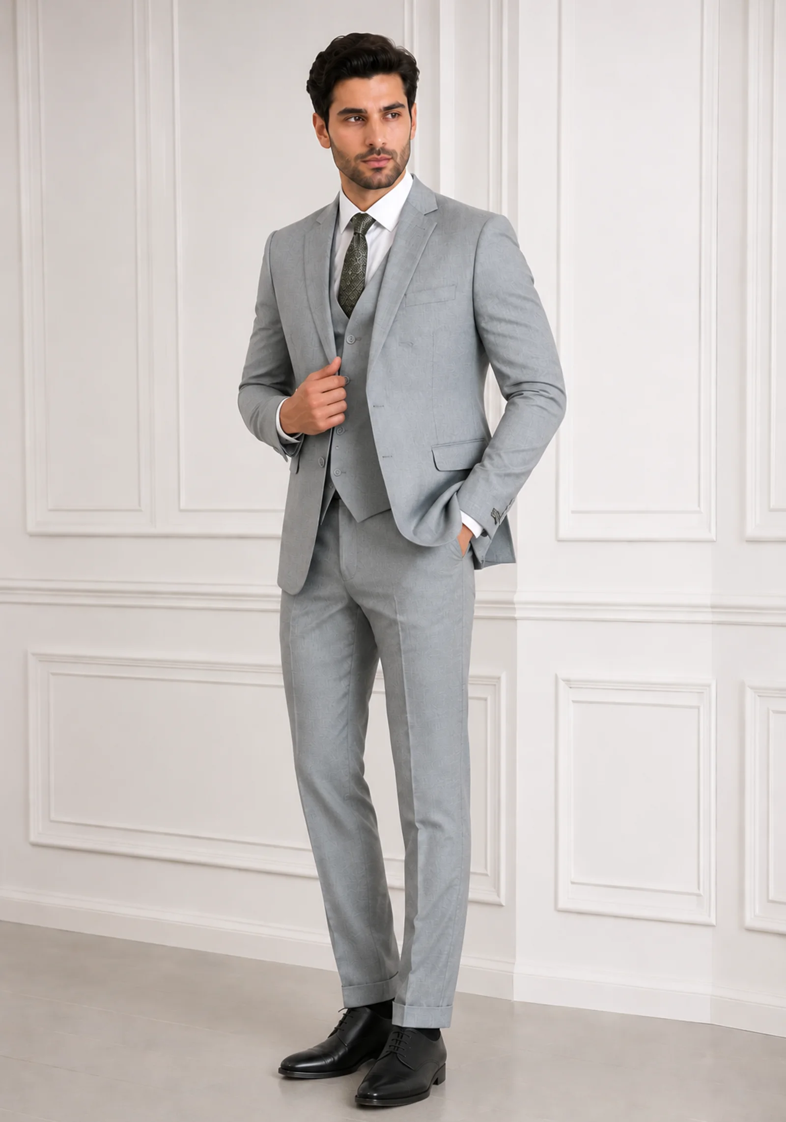 A gentleman wearing the "Silver Sovereign" premium three-piece suit in #a4a19a color, showcasing sharp tailoring and refined hand-made Zari work surface ornamentation as seen in 55.webp, 66.webp, 77.webp, and 99_2.webp.