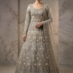 A model wearing a premium silver grey Farshi Lehnga with intricate hand-made Zari work and a modest long-length shirt.