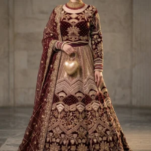 Front view of burgundy velvet bridal lehnga with gold zari work by AL Hassan Lehnga House