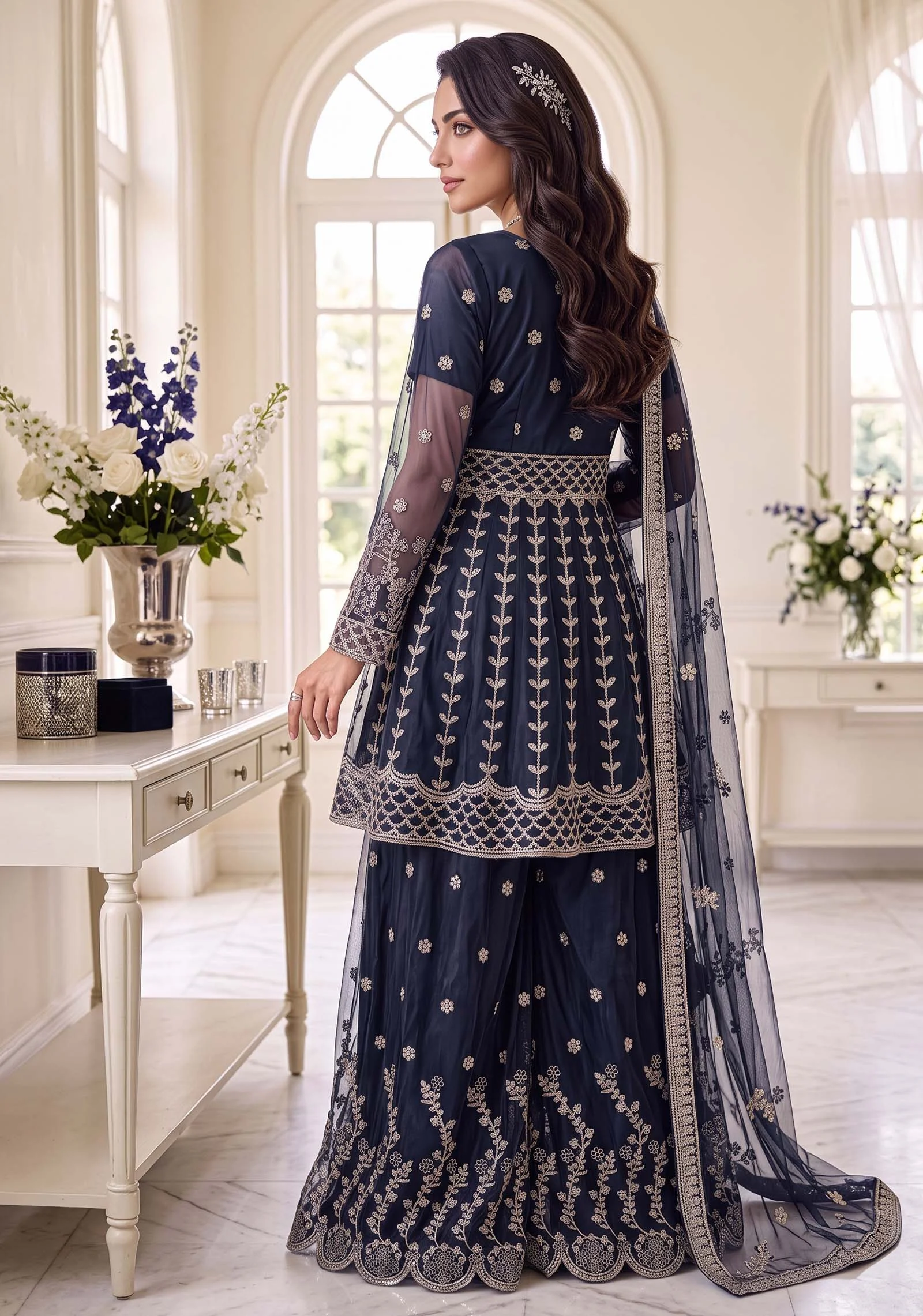 Back view of the navy blue peplum sharara showing the flare and cutwork by AL Hassan Lehnga House